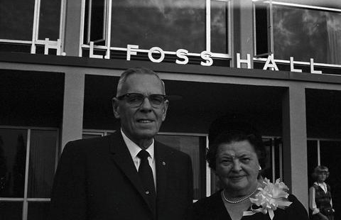 H.L. and Elise Fosses stand in front of Foss Hall.