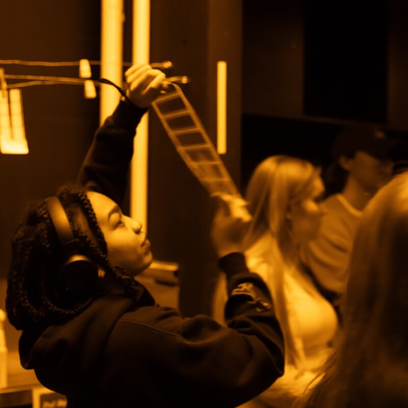A student developing film in the dark room
