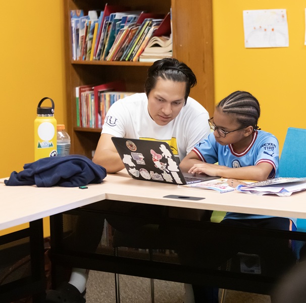 A student and a child working on homework in Parkland Literacy Center
