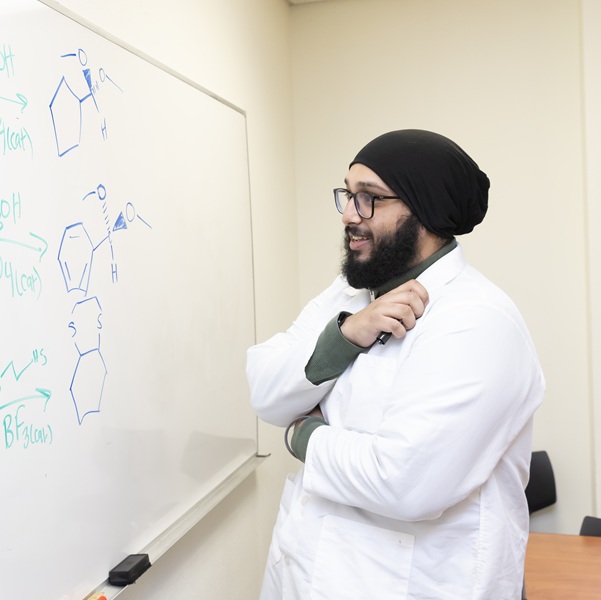 Student in front of a white board