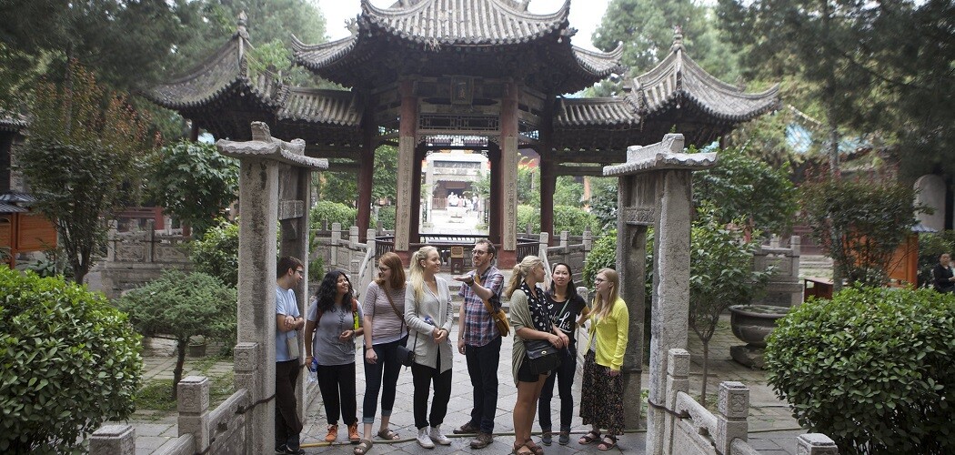 Students chatting and smiling with one another while studying abroad in China