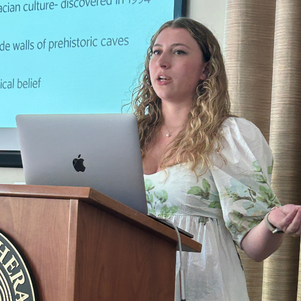 student presenting a presentation with macbook at morken