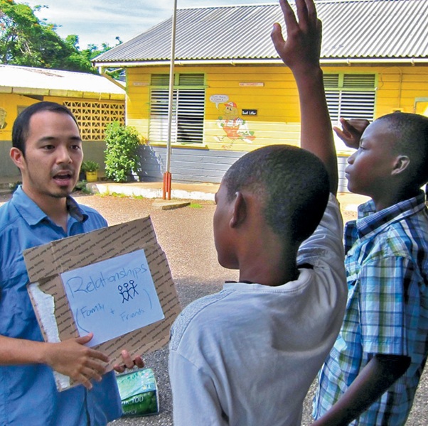 A man teaching two young boys the meaning of relationships