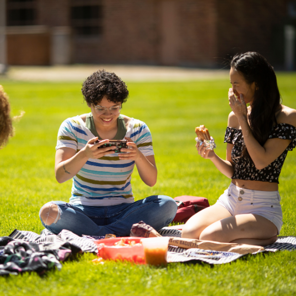 student having picnic at red square in spring