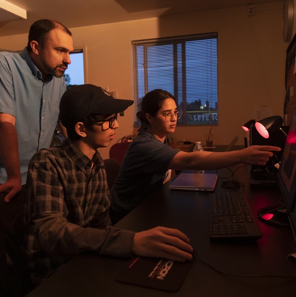 Physics professor Sean O’Neill and summer research students Julian and Jessica mount a 3D printed filter to the telescope in the W.M. Keck Observatory to ensure focusing accuracy as the group studies star clusters and variable stars