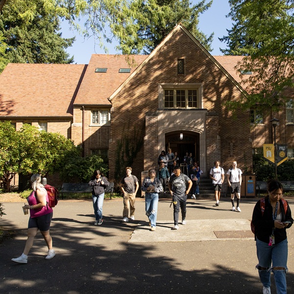 Students walking out of a building on a school day