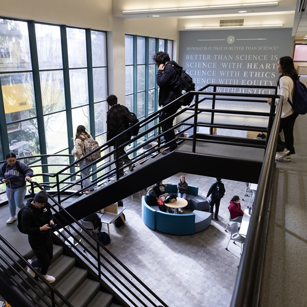 Student going down the stairs in Rieke Science building