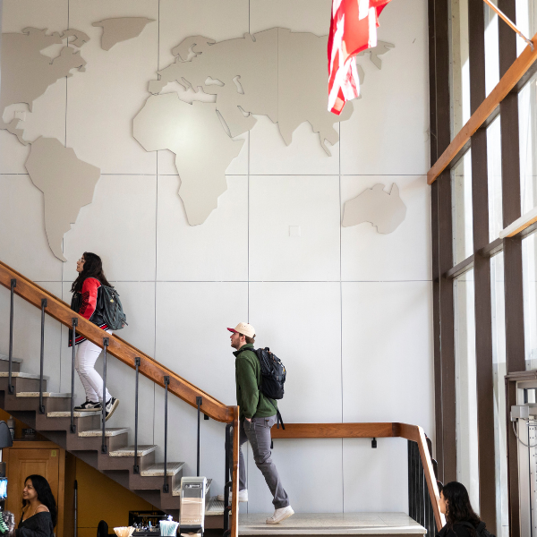 student in administration block walking up the stairs