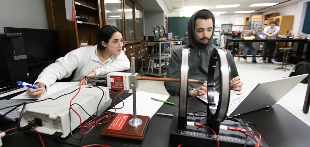 Two students work together during a physics lab.