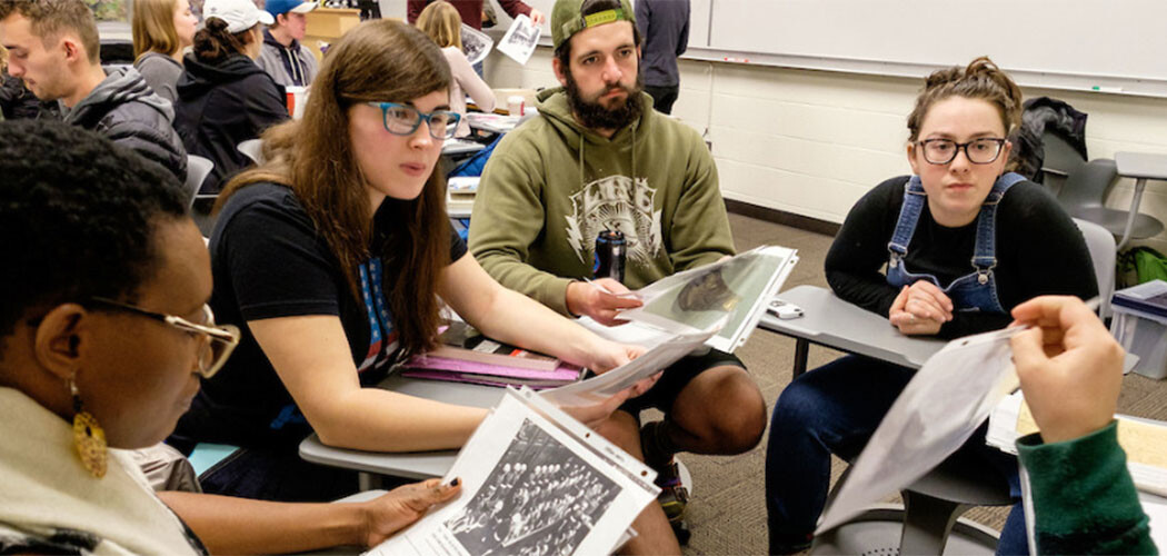 PLU students discussing Holocaust artifacts.