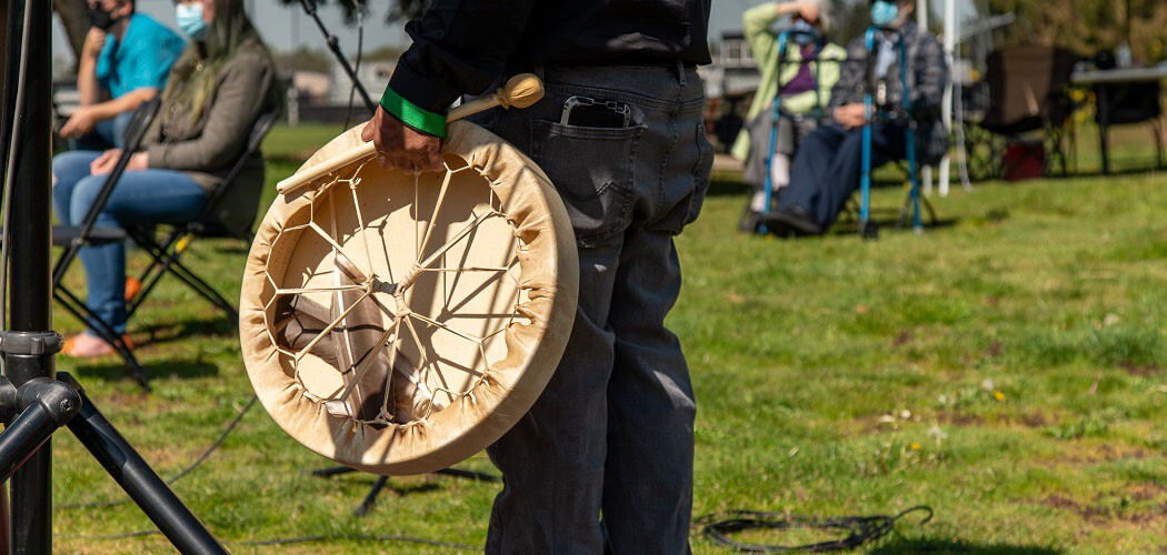 Standing with a drum.