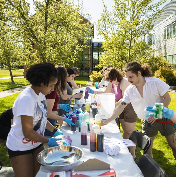 Students gather in between Morken and Rieke to tie-dye lab coats and other garments