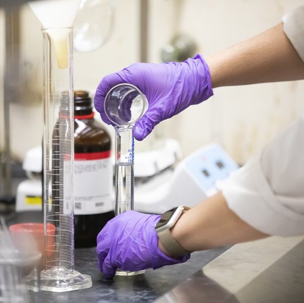 A close up photo of a student holding equipment
