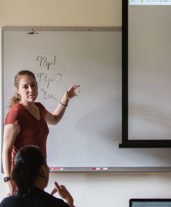 Kate Hoyt with reviewing student work in a group critique at PLU, Tuesday, Sept. 27, 2016. (Photo: John Froschauer/PLU)