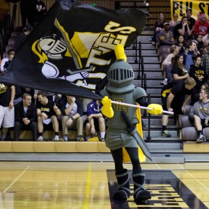PLU Knight mascot holding flag