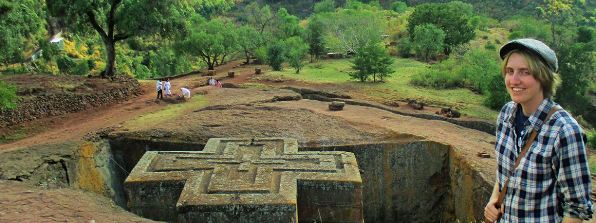 student with excavation site in background