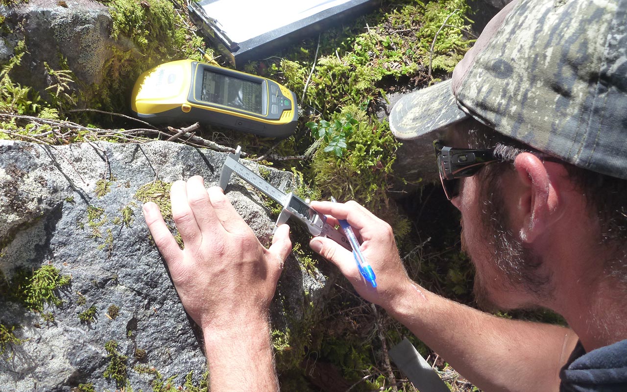 Measuring rocks at Mount Rainier for glacial research.