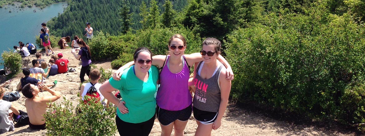 PLU student posing for a picture at the top of Snoqualmie Pass.