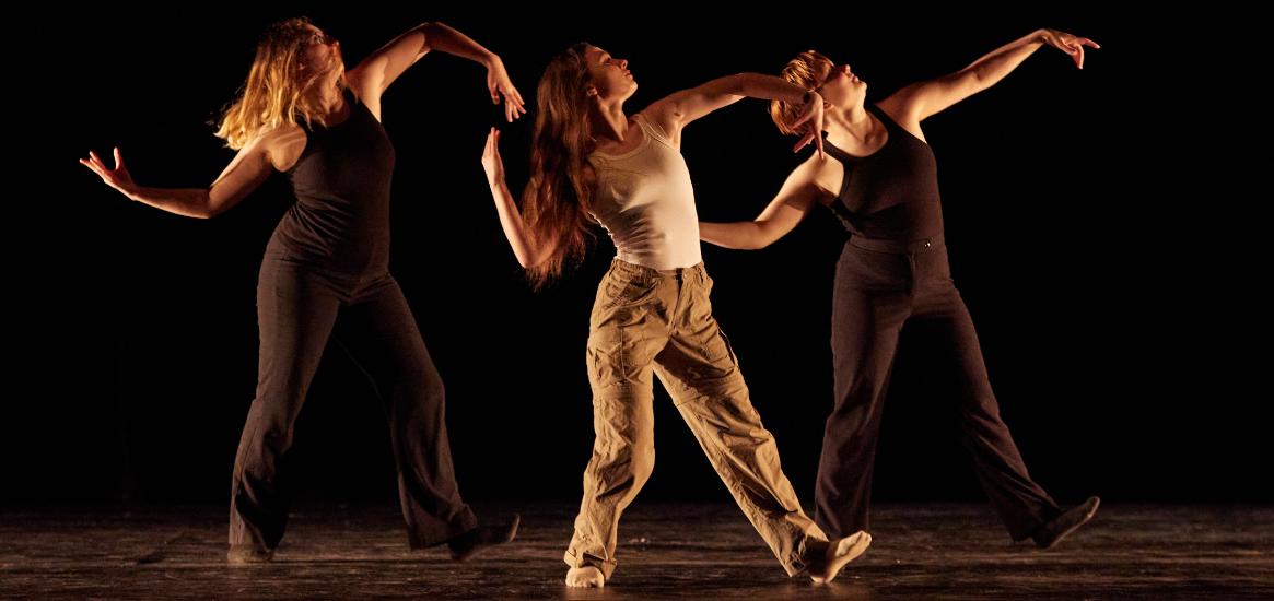 Dance Trio in neutral clothing looking to the side in Dance 2022 in Eastvold Auditorium.