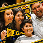 Family of PLU student holding pennants and smiling Family of PLU student holding pennants and smiling