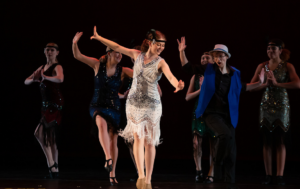 Six dancers in 20s flapper dresses and suit vest during Dance Concert 2023.