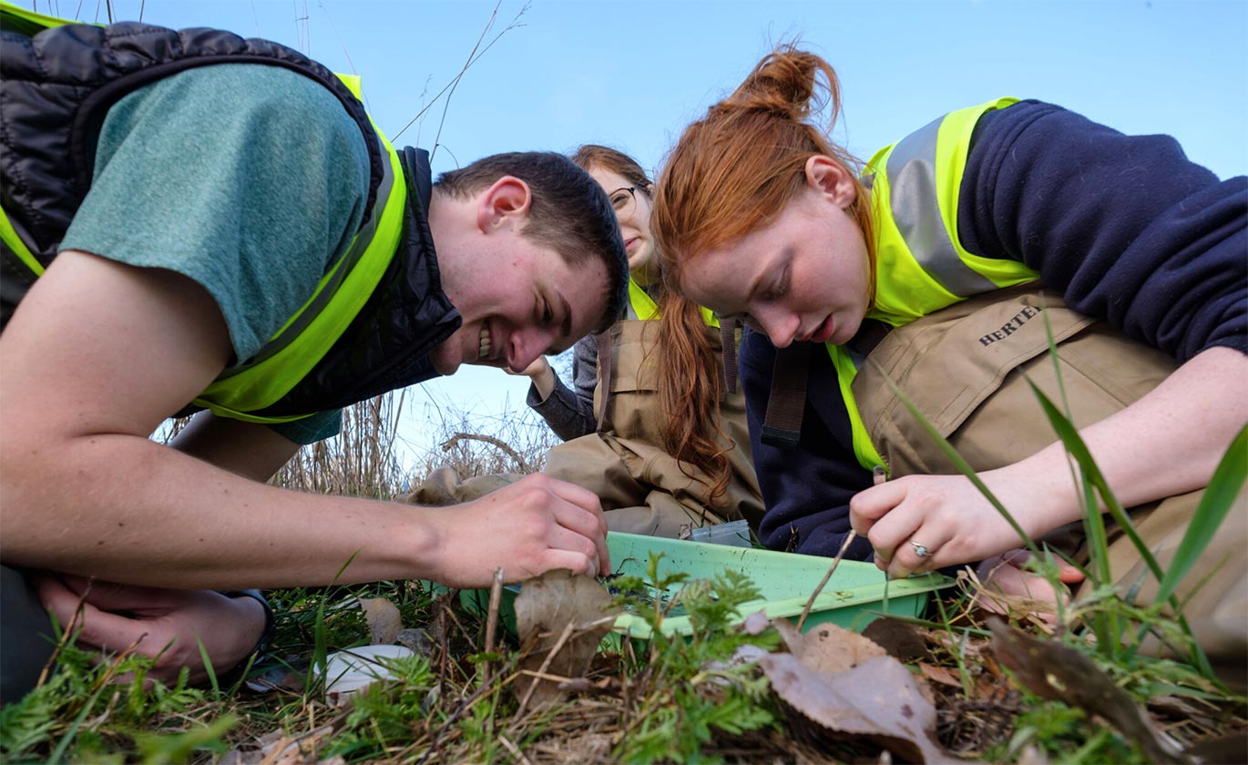 PLU students studying outside during field work