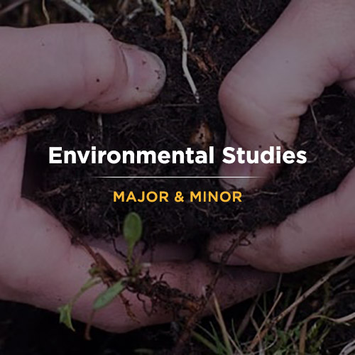 Student holding a big pile of dirt