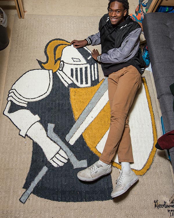 Hezekiah Goodwin laying on his PLU rug