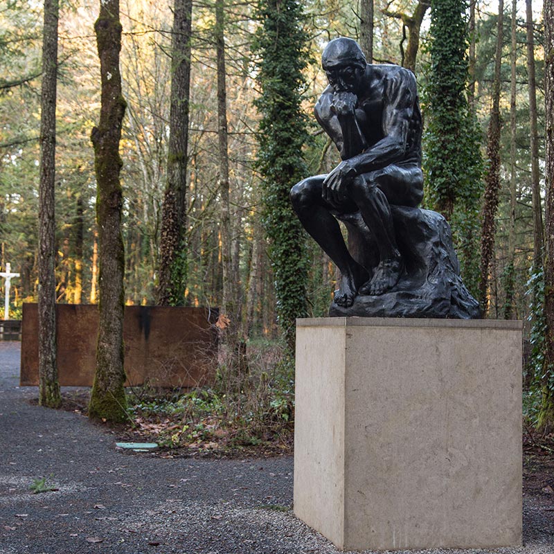 Photo of a statue of man with his hand underneath his chin