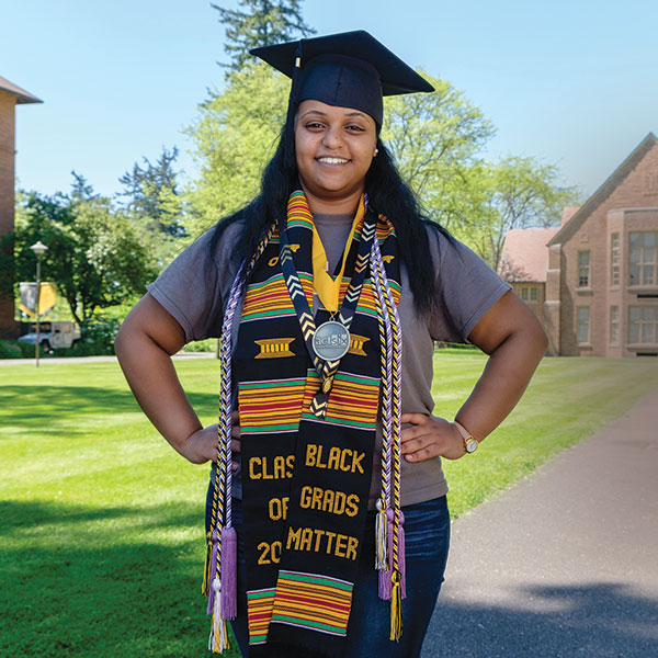 Samrawit Zeinu - standing with her graduation cap and medal