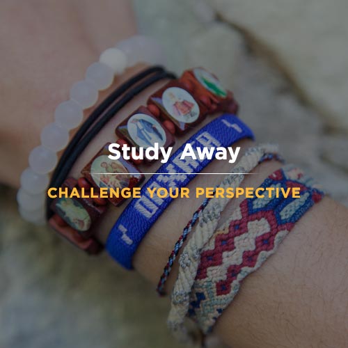 Close-up of a wrist wearing multiple colorful bracelets, including beaded and woven styles. The text Study Away and Challenge Your Perspective is overlaid on the image.