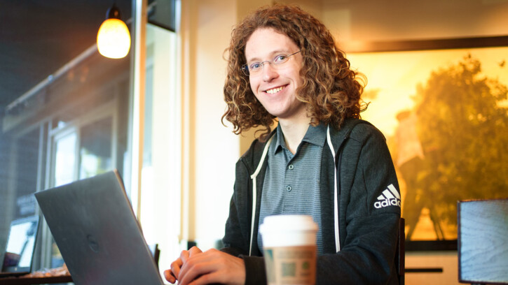 Conover typing on this laptop. He's seated in a coffee shop, a Starbucks up is just a few inches from his computer