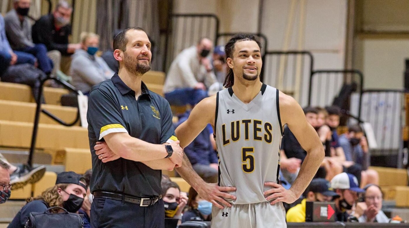 Jordan Thomas and Chad Murray talk during a basketball game.