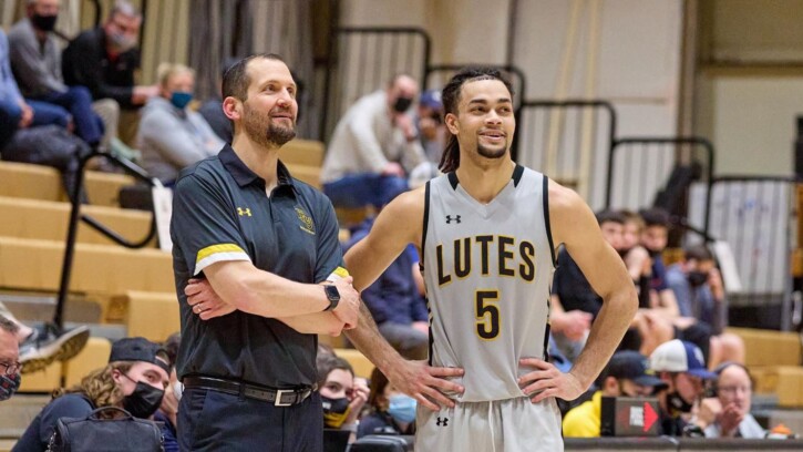 Jordan Thomas and Chad Murray talk during a basketball game.