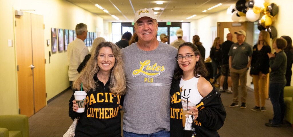 A PLU student and their family, all in Lute gear, pose for the camera during the Homecoming Lute Family Brunch, Saturday, Oct. 8, 2022, at PLU.