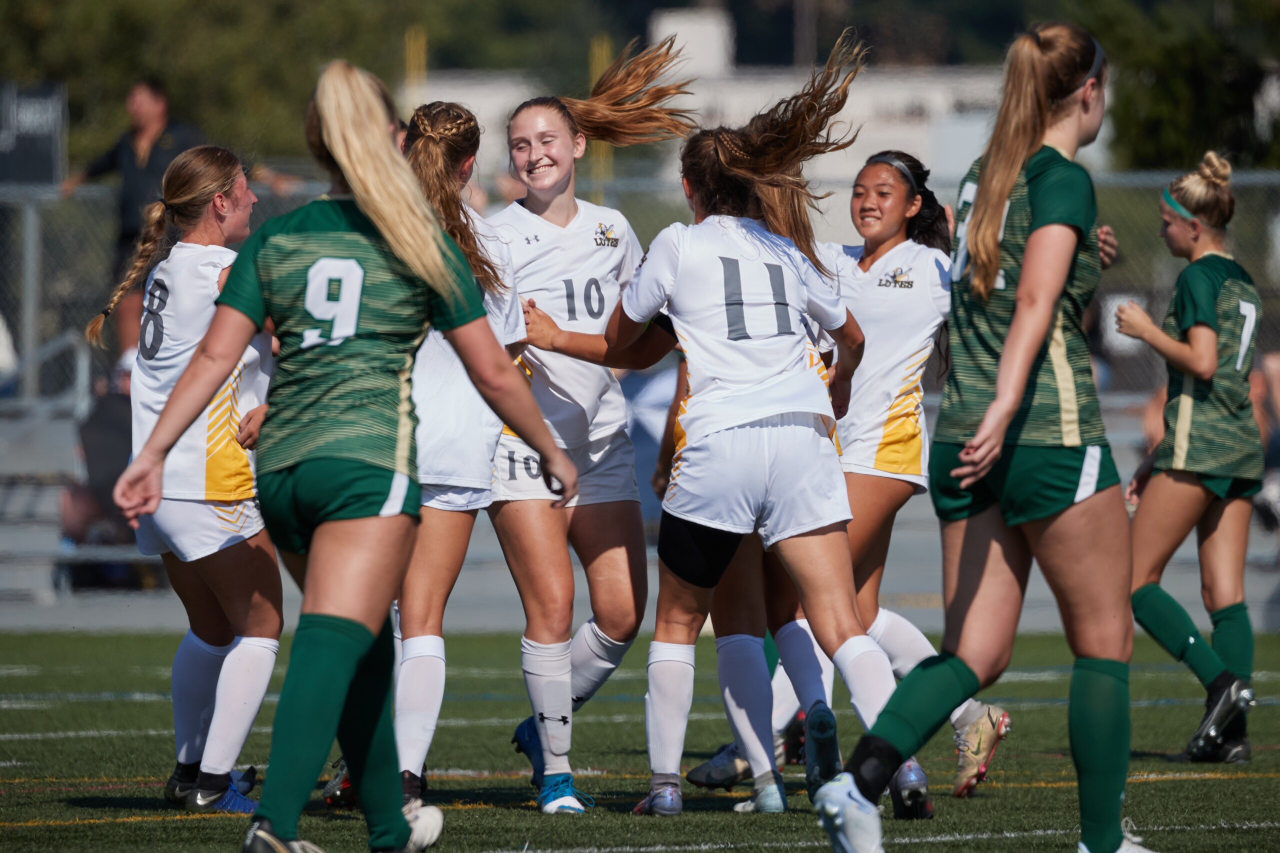 The PLU Women's Soccer team celebrates after a goal.