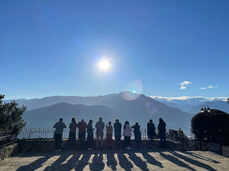 Greece Students are silhouetted and are looking at a large mountain in Greece.