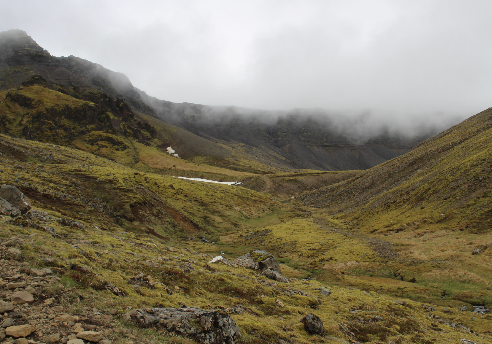 A landscape photo of Mt. Esja with fog over the mountain range.