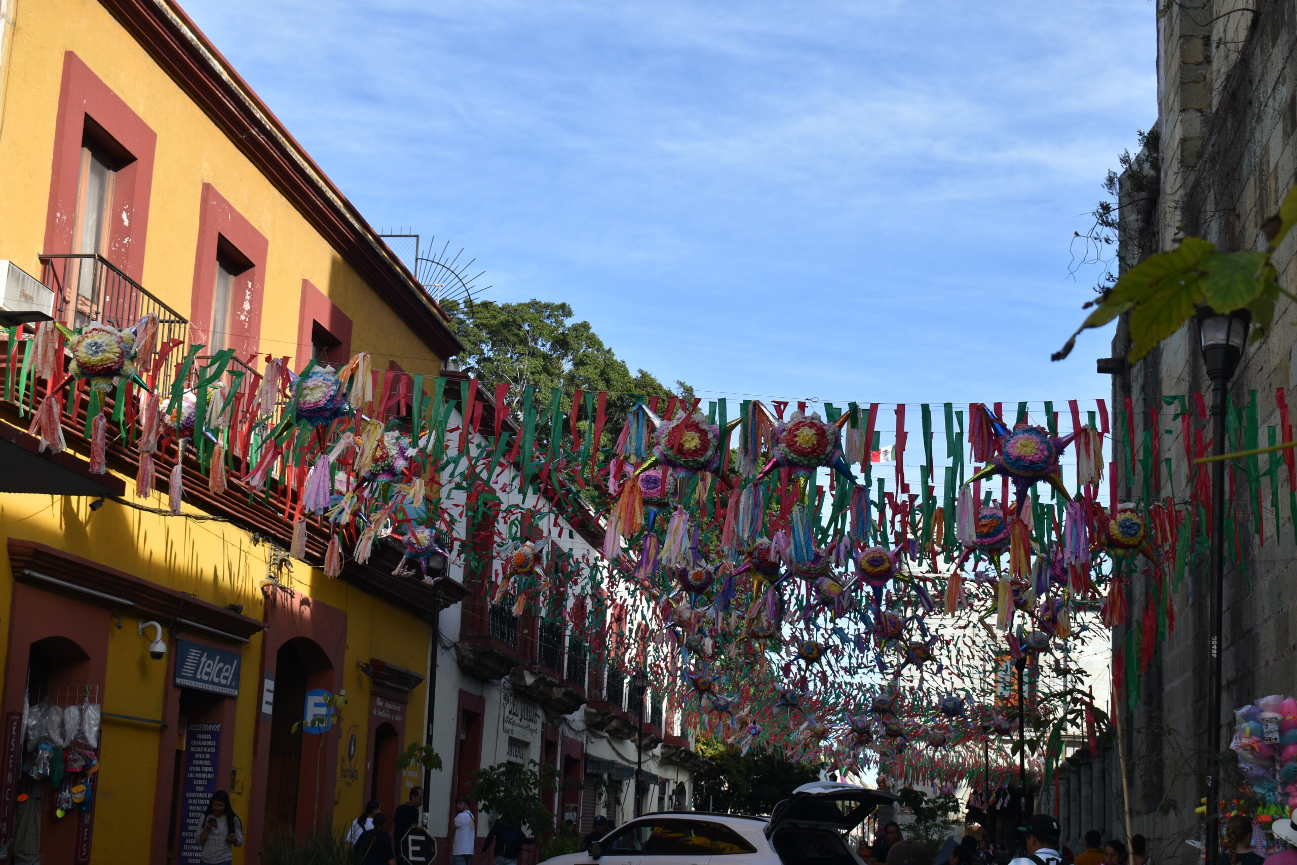 Piñatas and flags hang across buildings and the streets in Oaxaca, Mexico.
