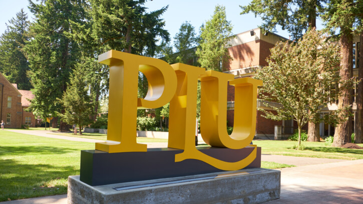 Photo of the yellow PLU sign on campus.