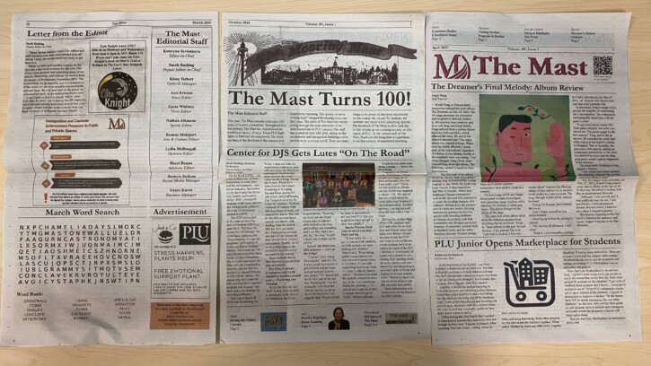The Mast newspapers laid out on a table.