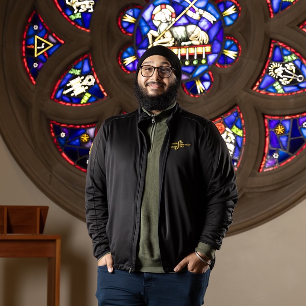 Blog - Justinpal S 02 Chemistry and Religion double major Justin Singh in front of Rose Window at KHP.