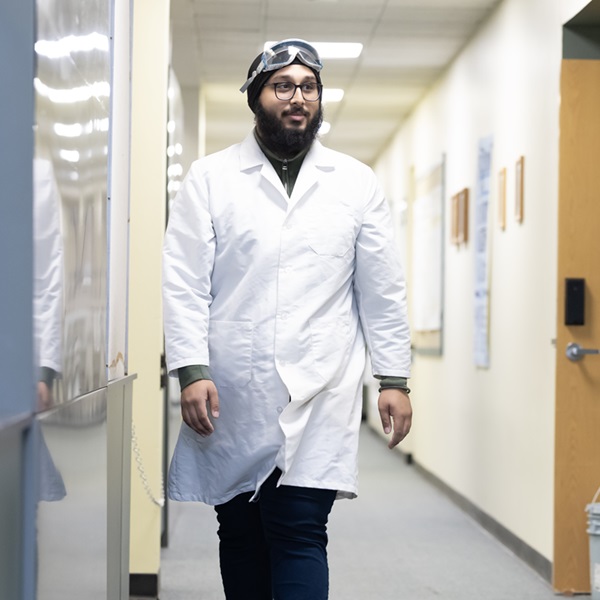 Blog - Justinpal S 03 Chemistry and Religion double major Justin Singh in a lab coat.