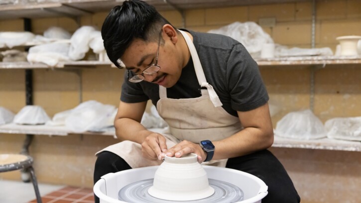 Senior graphic design major Guillermo Baltazar-Munoz works in the ceramics studio, Thursday, April 24, 2025, in Ingram Hall at PLU.