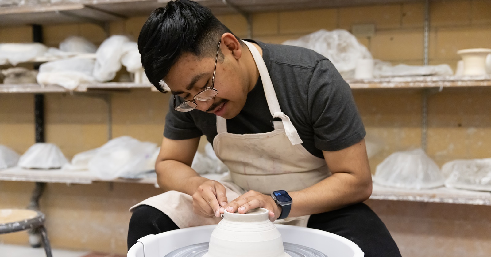 Senior graphic design major Guillermo Baltazar-Munoz works in the ceramics studio, Thursday, April 24, 2025, in Ingram Hall at PLU.