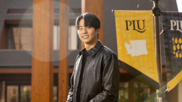 PLU Student standing in front of Anderson University Center