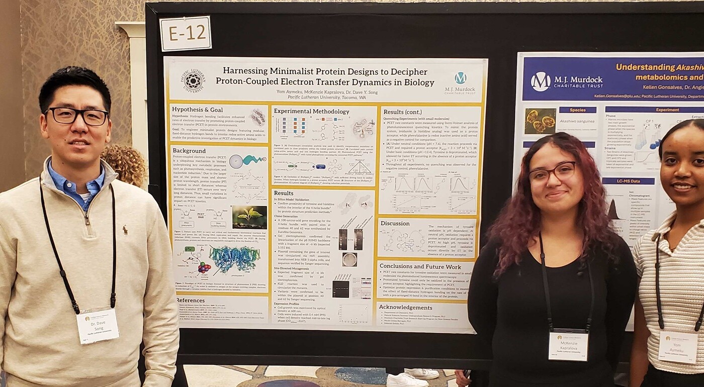 Students standing in front of the research banner