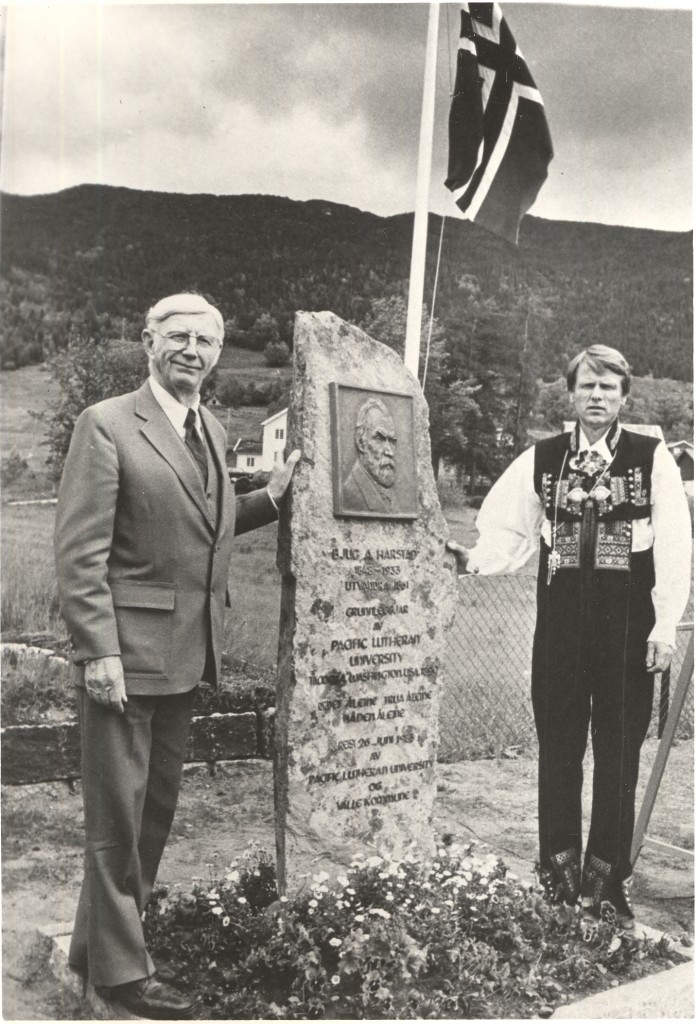 Adoph Harstad and the Mayor of Valle stand with monument for Bjug Harstad in his birthplace of Valle, Norway.