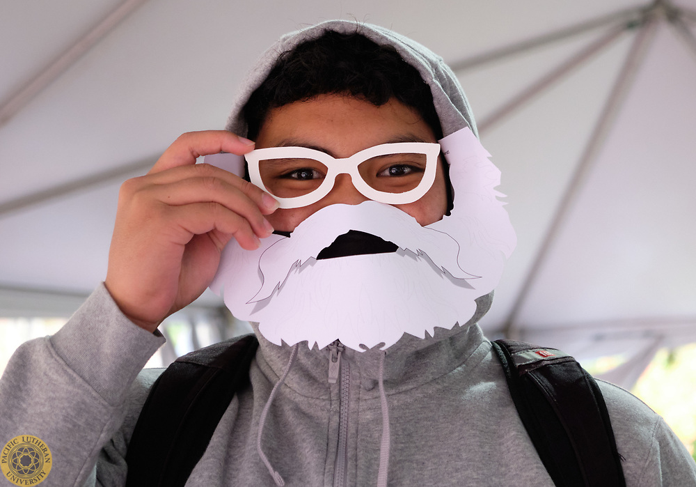 Student smiling with Bjug Day Beard and prop glasses