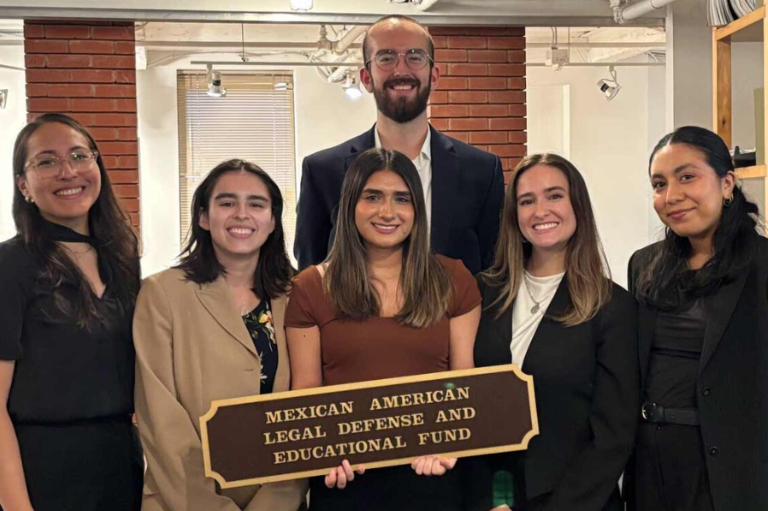Areli Arauja Ruiz and colleagues holding a sign that reads "Mexican American Legal Defense and Educational Fund"